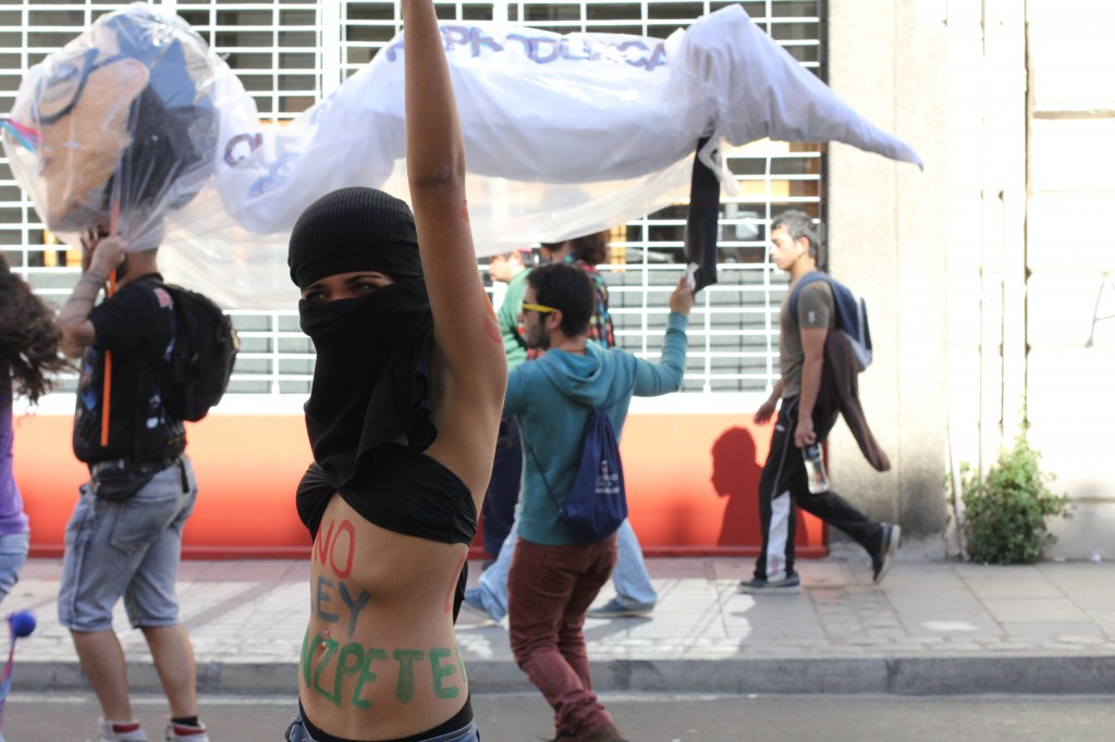 Her body is protesting the "Ley Hinzpeter," a law which, if passed, will harshly punish most forms of protests or demonstrations.